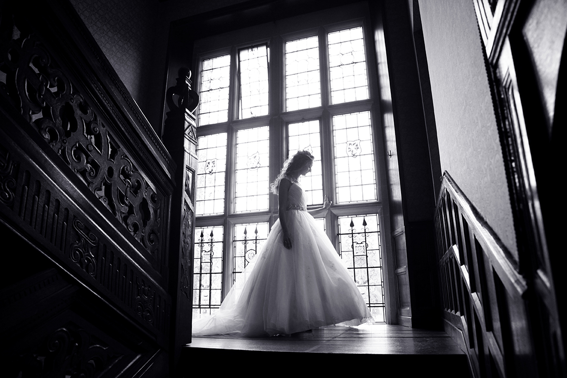 Bride on staircase at Hanbury Manor