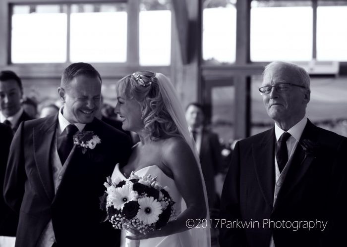 Groom seeing bride at Brocket Hall and proud Dad.