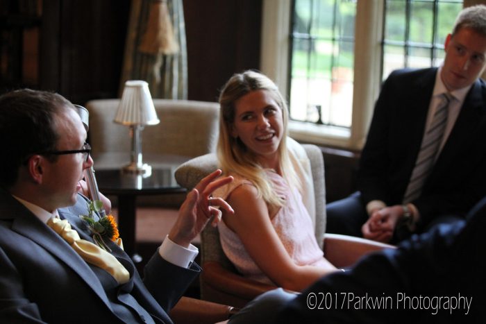 Groom talking to wedding guests at Hanbury Manor